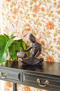 Side table with flowers and interior decoration Stock Photos