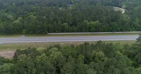 Side on tracking of cyclist on main road drone aerial 4K Stock Footage 111362277
