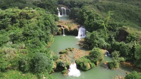 Side Tracking Drone Shot Across Multi Level Waterfalls and Emerald Pools Guangxi Stock Footage 330280015