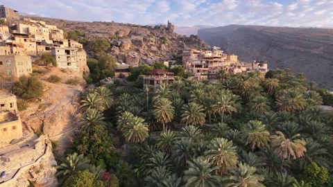 Side-tracking drone shot of Misfat Al Abriyeen village in Wilayat Al Hamra Stock Footage 337870261
