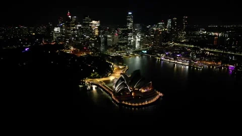 Side tracking night shot of Sydney Opera House, Circular Quay and city Stock Footage 276194296