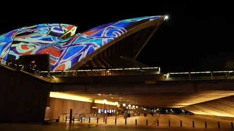 Side tracking Sydney Opera House lit up VIVID 6K Stock Footage 311142461
