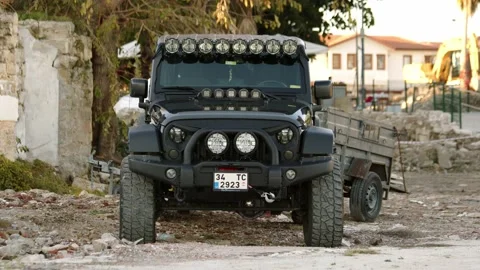 Side, Turkey - CIRCA 2022: black aggressive Jeep Wrangler Rubicon stand parked Stock Footage 226044839