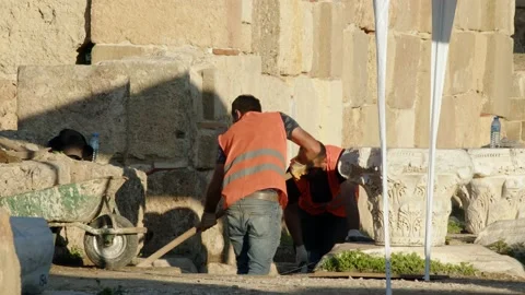 Side, Turkey - CIRCA 2022: Two workers are working on excavations of ancient Stock Footage 229485122