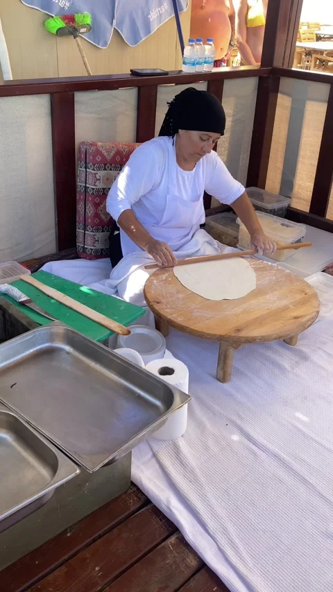 Side, Turkey, June 30, 2025. A Turkish woman rolls out dough Stock Footage 314972170
