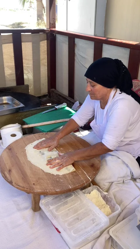 Side, Turkey, June 30, 2025. Turkish woman bakes Gozleme flatbread Stock Footage 314972173