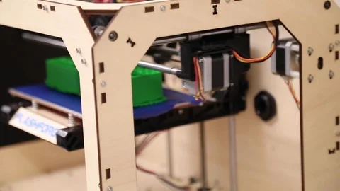 Side view of 3-D printer in wood laser cut frame Stock Footage 123976730