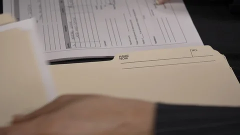 Side view - accountant putting forms in folders 4k Stock Footage 96020285