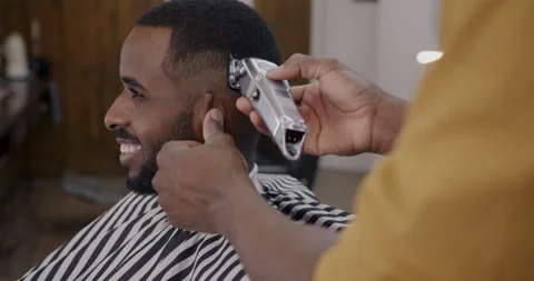 A Barber is Going through the Electric Cutting and Shaving Machine for the  Beard of an African-American Brazilian Boy Stock Image - Image of beauty,  business: 214303807