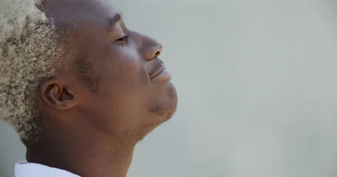 Side view african man afro american guy teenager blond student standing outdoors Stock Footage 142392640