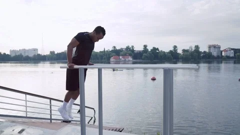 Side view of african man doing triceps dip exercise Stock Footage 121321301