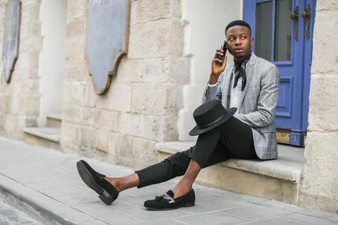 Side view of african man using smartphone outdoors 스톡 사진