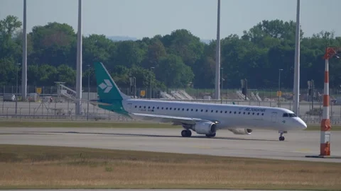 Side view of Air Dolomiti passenger airplane taxiing on the taxiway Stock Footage 246708853