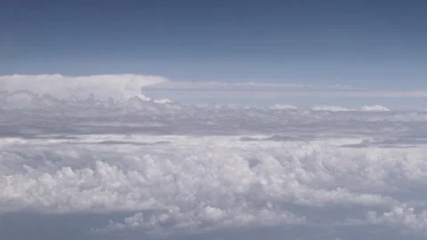 Side view from an airplane window to the horizon line between layers of white Stock Footage 253993368