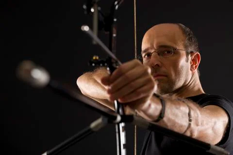 Side view of archer with bow and arrow. Stock Photos