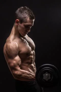 Side view, arm biceps triceps young bodybuilder dumbbell exercise Stock Photos