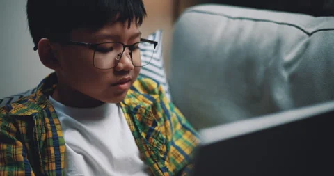 Side view, Asian boy wearing glasses schoolboy using a laptop computer Stock-Footage 241902261