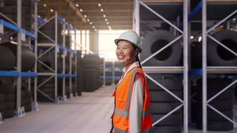 Side View of Asian Female Engineer Waving Hand Saying Bye While Walking at Tire Stock Footage 341784910