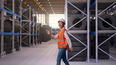 Side View of Asian Female Engineer Waving Hand Saying Bye While Walking at Tire Stock Footage 341785135