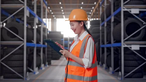 Side View Of Asian Female Engineer Looking At The Tablet In Her Hand Tire Stock Footage 341788275