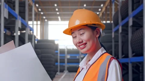 Side View Of Asian Female Engineer Looking At Blueprint In Her Hands Tire Video stock 341788992