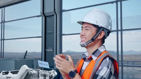 Side View Of Asian Male Engineer Smiling, Clapping Hands in High Tech Factory Stock Footage 274359901