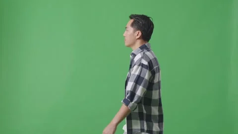 Side View Of Asian Man Walking In Green Screen Background Stock Footage 248007645