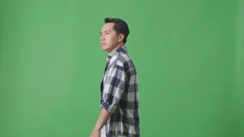 Side View Of Asian Man Walking And Looking Around In Green Screen Background Stock Footage 248007684
