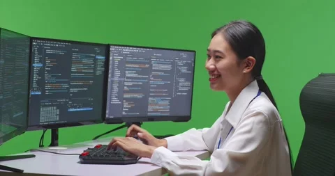 Side View Of Asian Woman Developer Using Computer To Write Code With Multiple Stock Footage 231166376