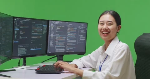 Side View Of Asian Woman Developer Smiling To Camera While Write Code With Stock Footage 231170884