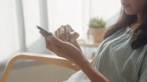 Side view. Asian woman using smartphone via technology at home Stock Footage 263000843