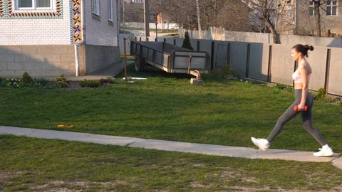 Side view of athletic young brunette girl in sport clothes doing squat exercises Stock Footage 127643336