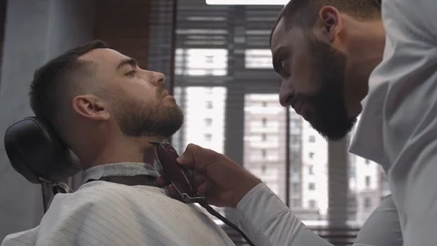 Side view attentively handsome young barber with beard Stock Footage 112340028