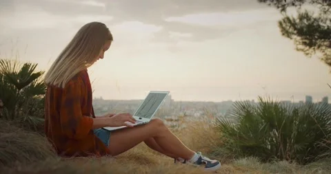 Side view of attractive Caucasian young female using laptop to be online Stock Footage 138810959
