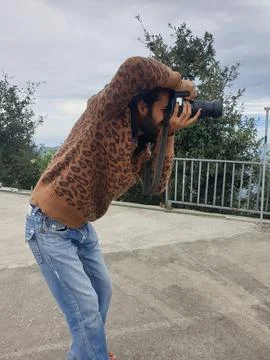 Side view of a attractive long haired and bearded young man photographer  Stock Photos