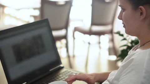 Side view Authentic Young Woman Chatting On Laptop At Home In Living Room Stock Footage 172080882