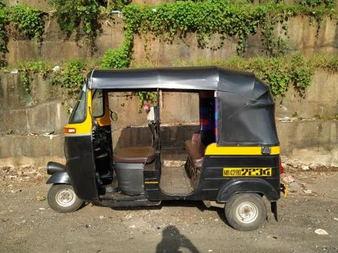 Side view of an auto rickshaw standing on the street of India. Stock Photos
