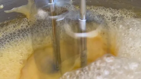 Side View Of Automatic Stand Mixer Whisking Eggs With Fluffy White Foam Stock Footage 334365284