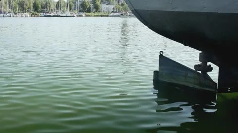 Side view of the back of a large moored ship with a balanced rudder in the c Stock Footage 259506288