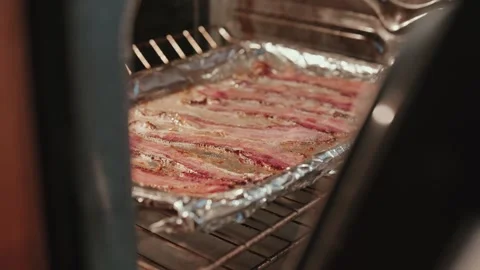 Side view of bacon cooking in oven Stock Footage 300509269