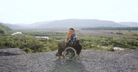 Side view of balanced handsome disabled man in wheelchair after desease or Stock Footage 139938404