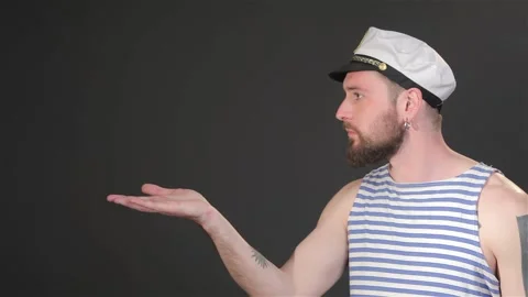 Side view of bearded captain sends air kiss Stock Footage 251464310