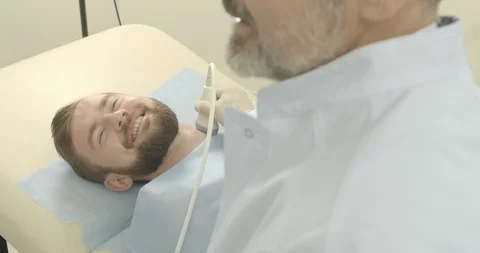 Side view of bearded man face lying on examination in medical cabinet. Doctor Stock Footage 105587946