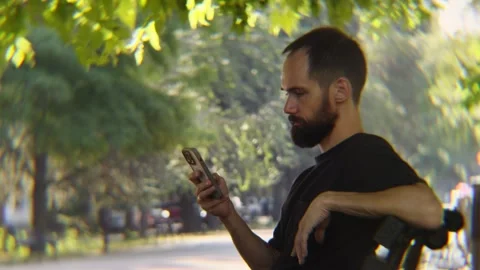 Side View of Bearded Man Gesturing While Sitting Bench Outdoors Video stock 342824605