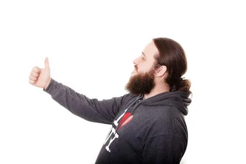Side view bearded man with thumbs up expressing winning behavior Stockfoto's