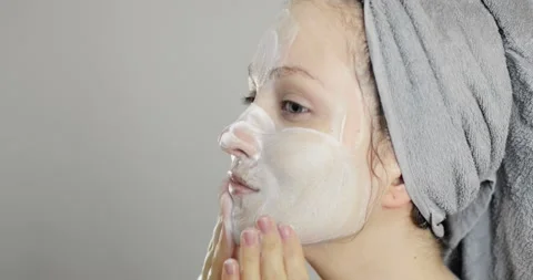 Side view of beautiful charming young girl lathering her face Stock Footage 151263243