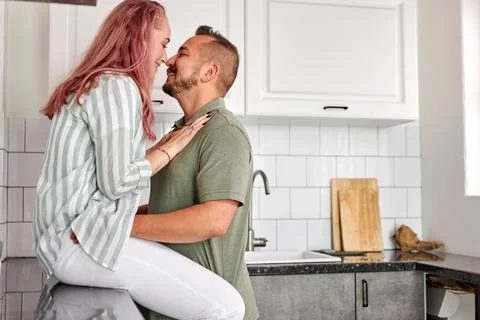 Side view on beautiful couple having romantic love time in the kitchen Stock Photos