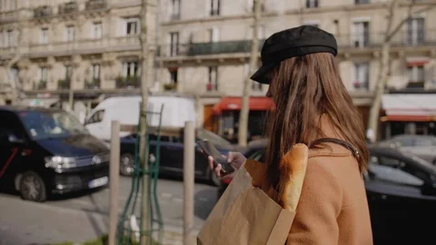Side view beautiful elegant food blogger woman walking along Paris street with Stock Footage 124265244