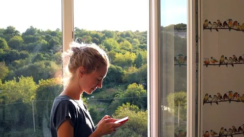 Side view of beautiful freelance young woman with smartphone talking on mobile p Video stock 117104863