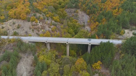 Side view of beautiful highway bridge in the mountains. Cars driving on asphalt Stock Footage 119596992